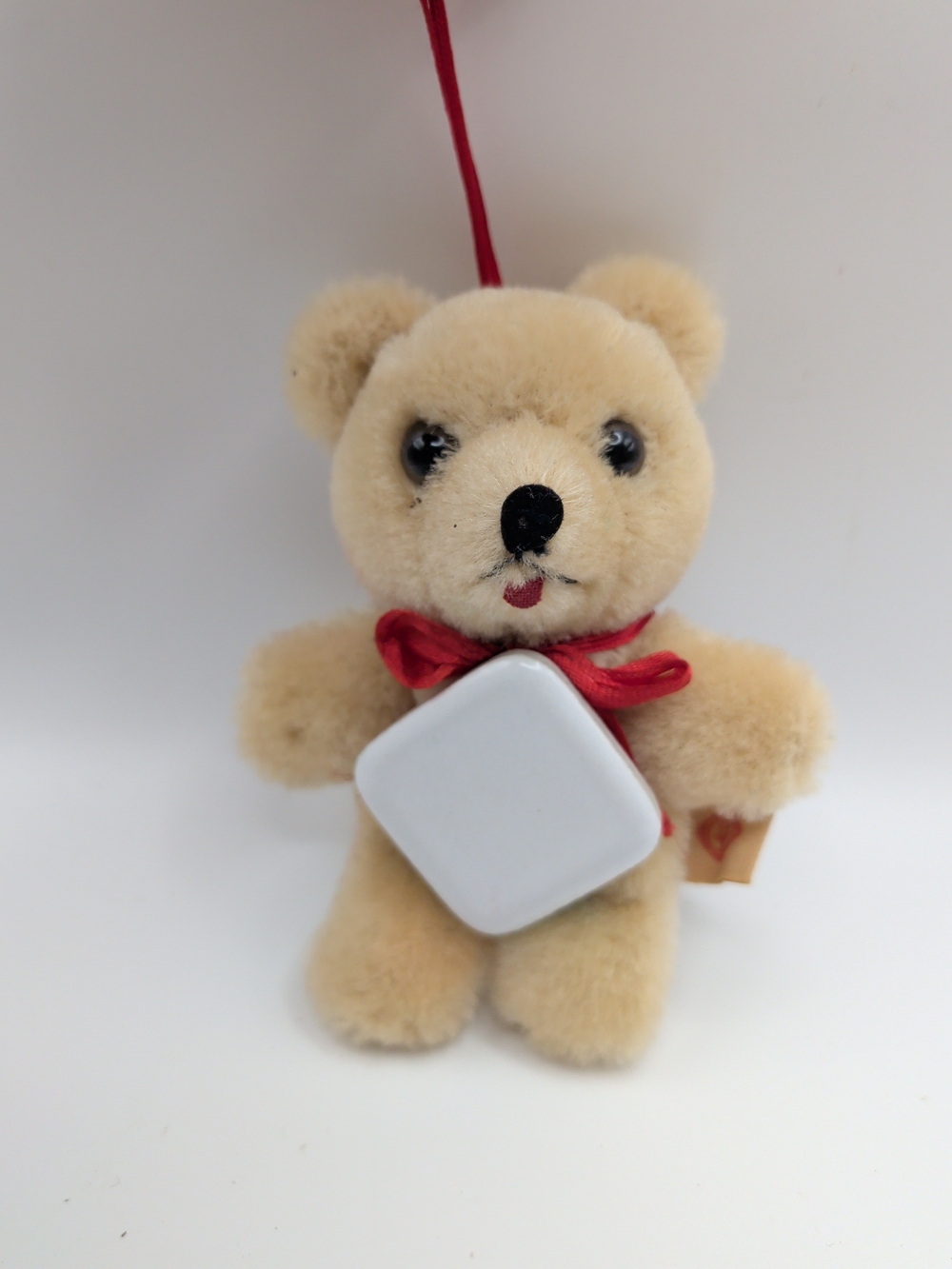 Plush Beige Teddy Bear Ornament with Red Bow